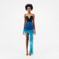 ÚCHÈ Denim Asymmetrical Feather Trim Skirt - High-waisted denim skirt featuring an asymmetrical design with a mini side and a maxi side, adorned with blue feather trim detailing.