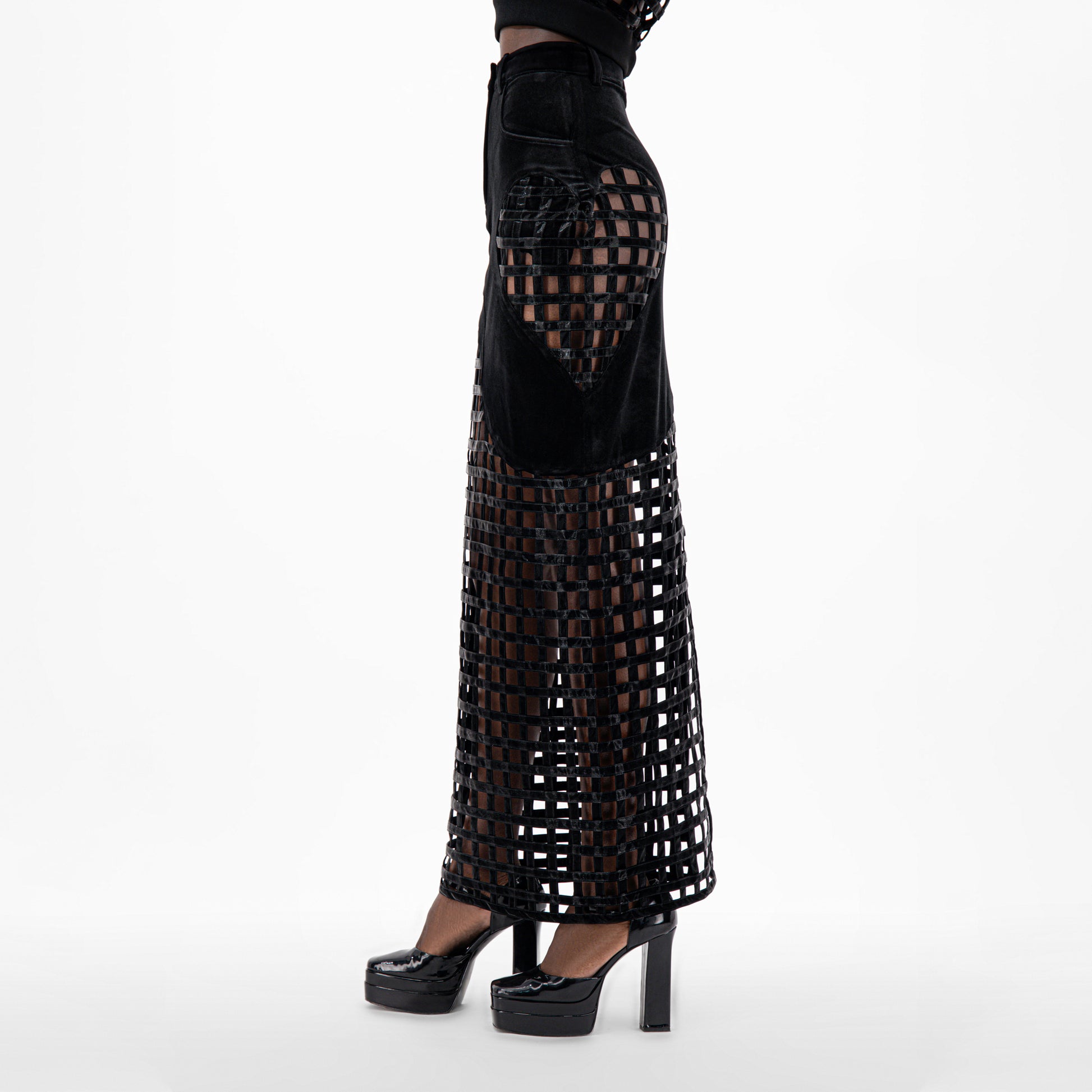 Black Velvet Maxi Skirt featuring a unique open grid design, high waist, and heart detail at hip.