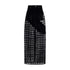 Black velvet maxi skirt with heart-cut hip details and front pockets, showcasing a bold silhouette.