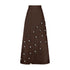 Cowrie Detail Denim Maxi Skirt - Brown, high-waisted A-line denim skirt with cowrie embellishments and pockets.