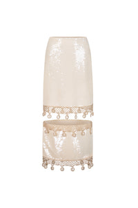 Floating sequin midi skirt featuring cream color, crochet hemming, and hand sewn cowrie shells details.
